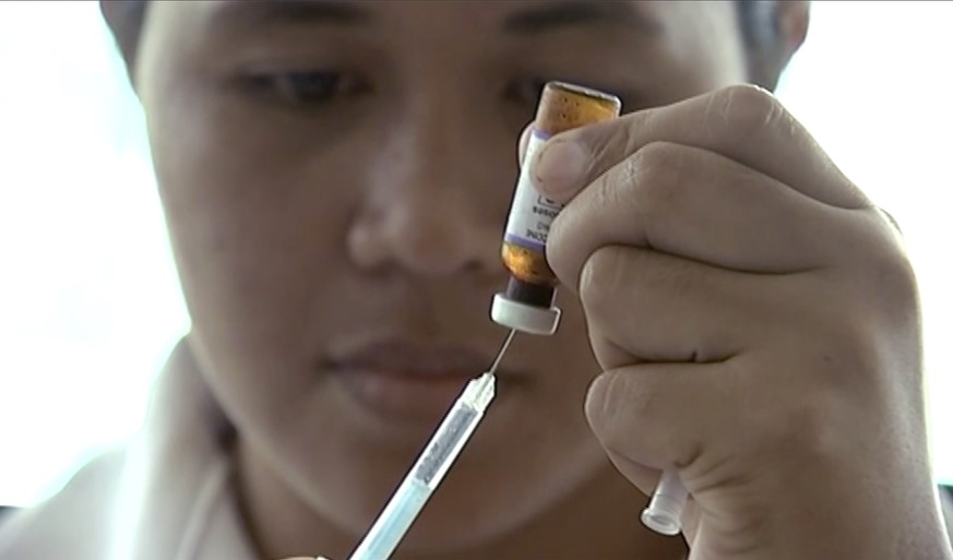 FILE - In this file image made from Nov. 25, 2019, file video, a New Zealand health official prepares a measles vaccination at a clinic in Apia, Samoa. A measles outbreak in Samoa has killed 50 babies ...