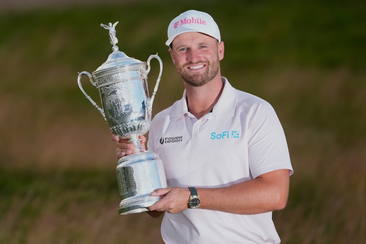 Wyndham Clark holds the trophy after winning the U.S. Open golf tournament at Shinnecock Hills Golf Club in Southampton, N.Y., Sunday, June 21, 2026. (AP Photo/David J. Phillip)
Wyndham Clark