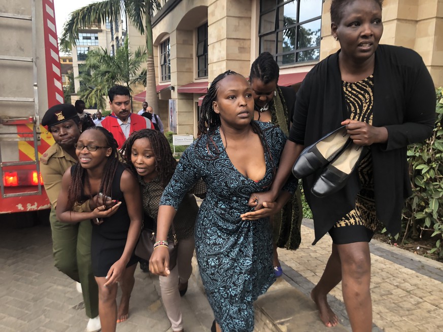 epa07286603 People run for cover during an ongoing gunfire and explosions in Nairobi, Kenya, 15 January 2019. According to reports, a large explosion and sustained gunfire sent workers fleeing for the ...