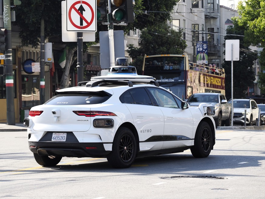 epa10875989 A Waymo autonomous vehicle makes its way through traffic in the North Beach district in San Francisco, California, USA, 21 September 2023. City of San Francisco officials, fire chief, and  ...