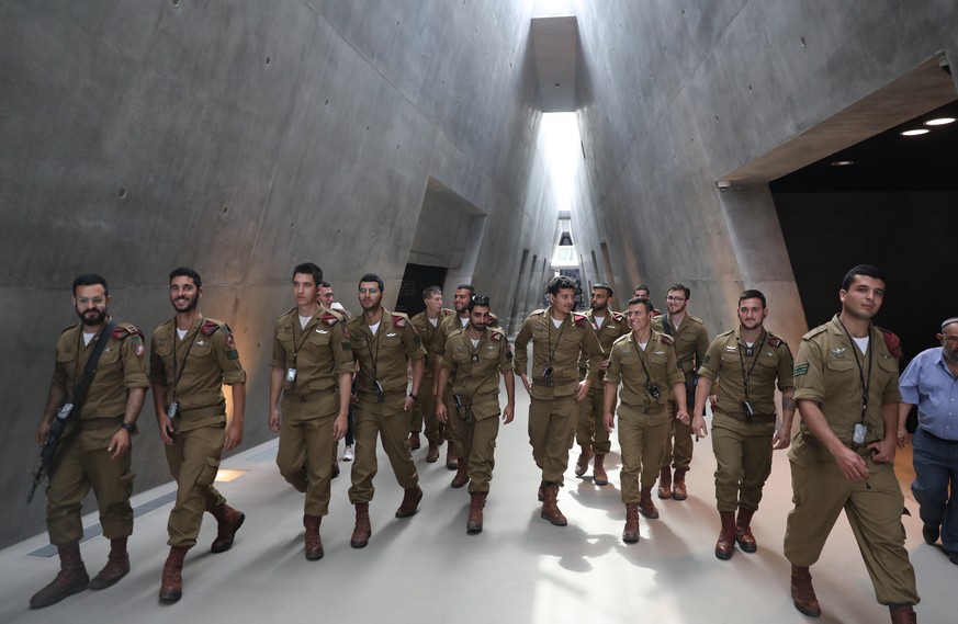 epa09911575 Israeli soldiers walk in the Yad Vashem Holocaust Memorial Museum in Jerusalem, Israel, 27 April 2022. Israel will mark Holocaust Remembrance Day on the eve of 27 April. EPA/ABIR SULTAN