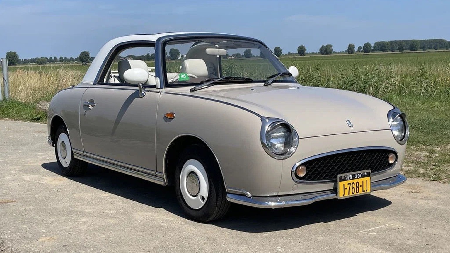 1991 Nissan Figaro 
https://www.route66auctions.com/product/nissan-figaro-1991-n8658-5/