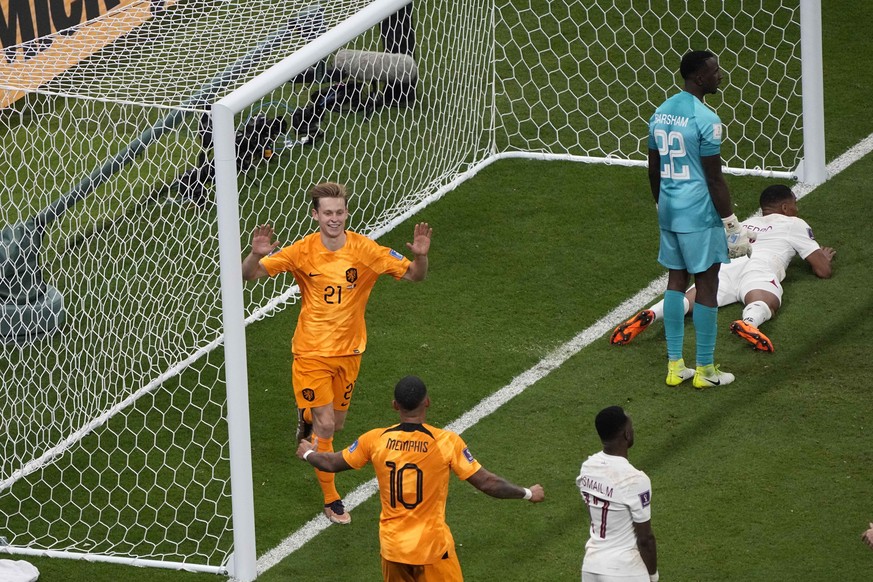 Frankie de Jong of the Netherlands, top, celebrates with his teammate Memphis Depay after scoring his side's second goal during the World Cup group A soccer match between the Netherlands and Qata ...