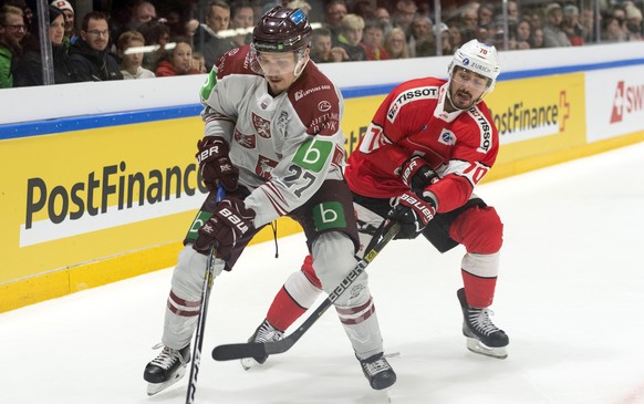 Latvias&#039;s Oskars Cibulskis, left, in action against Switzerland&#039;s Denis Hollenstein, during the friendly Ice Hockey match between Switzerland and Latvia in Weinfelden, Switzerland, Saturday, ...