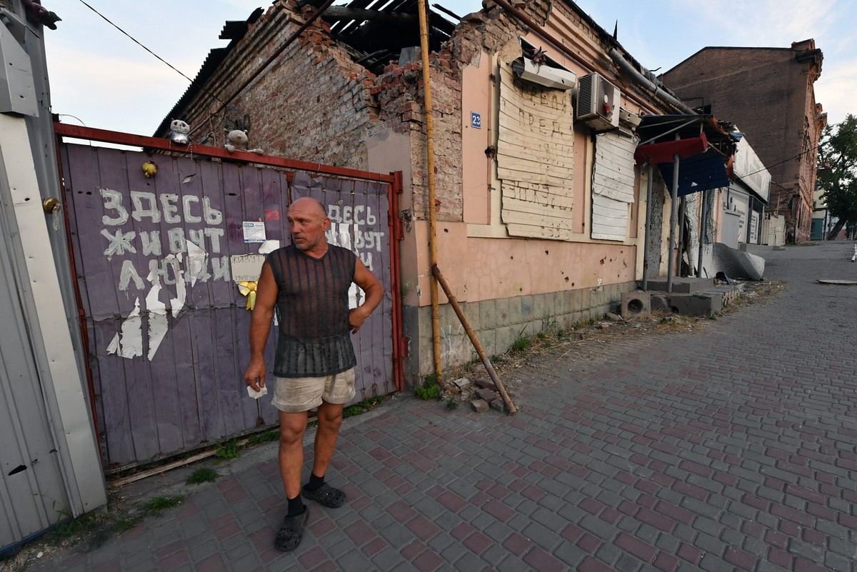 Sergei, 52, who builds advertising billboards, meets with AFP reporters at his partially destroyed city centre house, which was hit by two missiles in 2022, in the Russian-controlled Azov Sea port cit ...