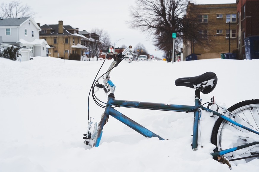epa10378188 A bike is engulfed in snow as the effects of a massive winter storm which has affected large portions of the United States, continues in Buffalo, New York, USA, 25 December 2022. Much of t ...