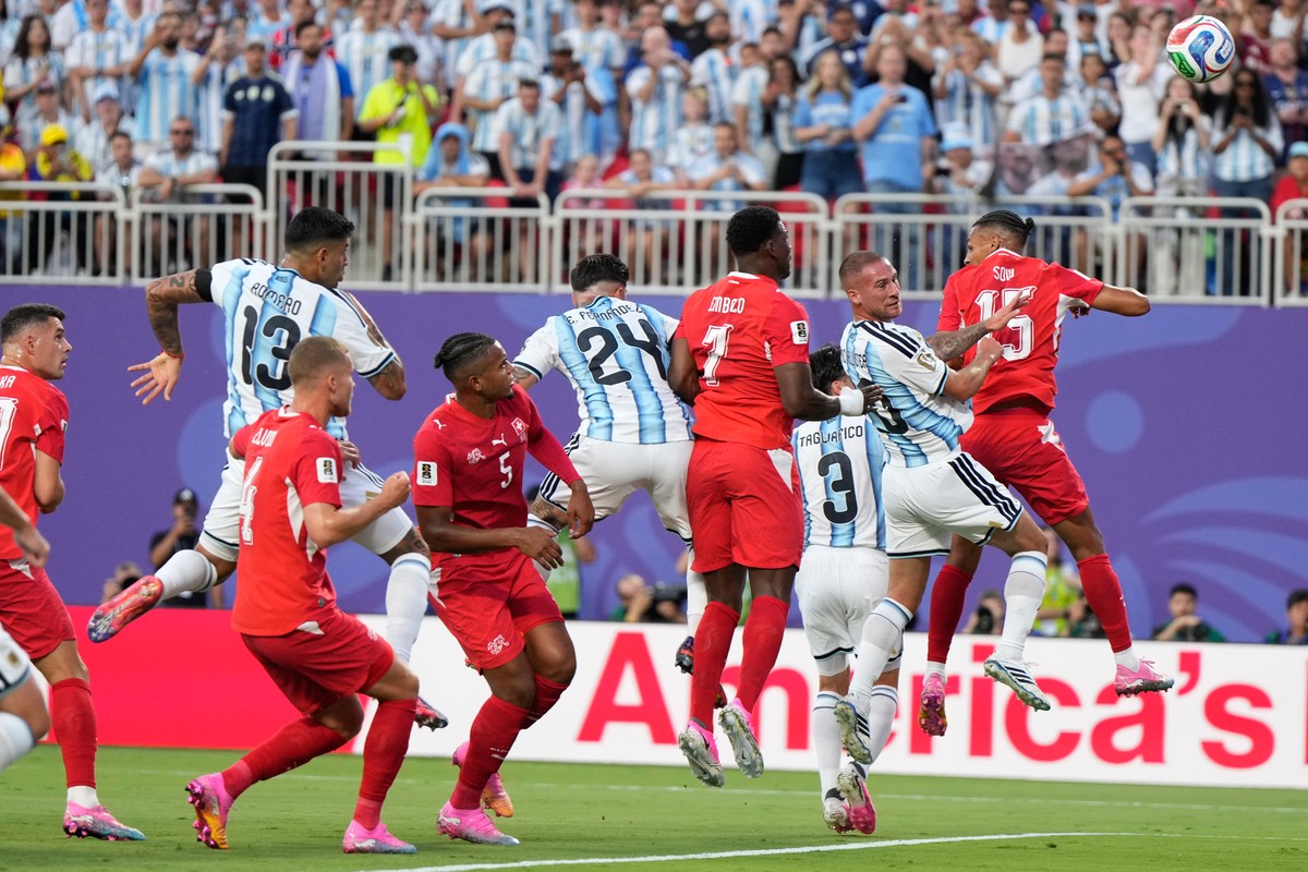 Argentina's Alexis Mac Allister (20), second right, scores their opening goal during the World Cup quarterfinal soccer match between Argentina and Switzerland in Kansas City, Mo., Saturday, July  ...