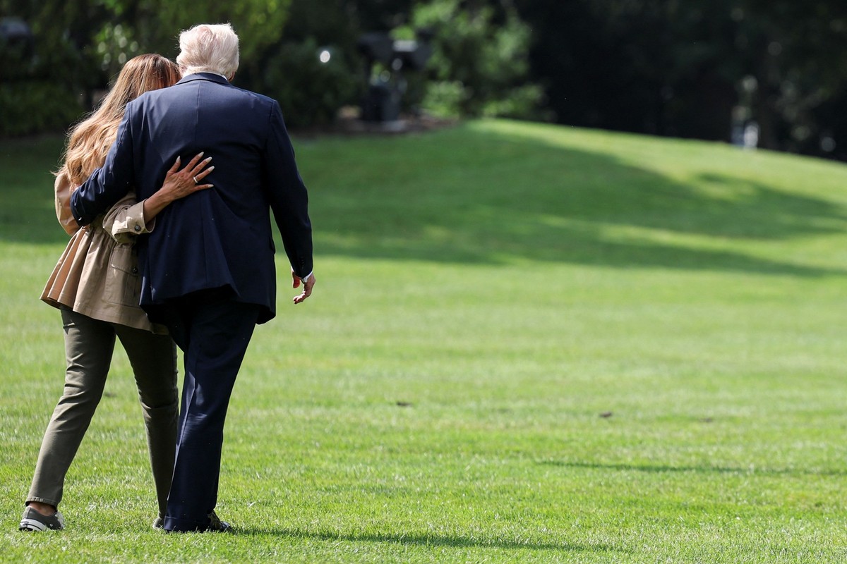 U.S. President Donald Trump and first lady Melania Trump walk towards Marine One, as they depart for travel to Texas to tour areas affected by deadly flash flooding, from the South Lawn of the White H ...