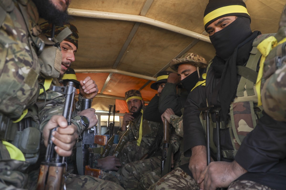 Syrian opposition fighters ride in a truck as they enter the village of Anjara, western outskirts of Aleppo, Syria, Thursday Nov. 28, 2024, part of their major offensive on government-controlled areas ...