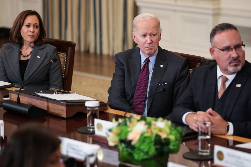 epa10223816 (L-R) US Vice President Kamala Harris, President Joe Biden and Secretary of the Department of Education Miguel Cardona listen during a meeting of the Task Force on Reproductive Healthcare  ...