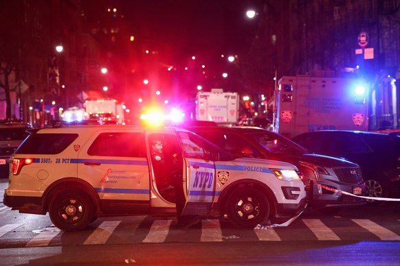 epa09701282 Crime scene units are seen on a closed portion of 135th Street, as members of the New York City Police Department investigate the scene where one officer was shot and killed, and another c ...