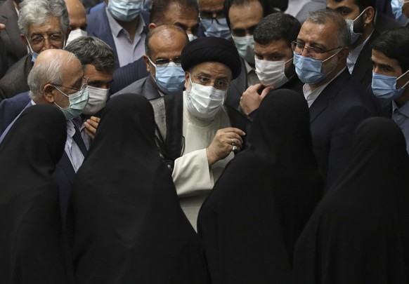 President Ebrahim Raisi, center, speaks with female lawmakers after taking his oath as president in a ceremony at the parliament in Tehran, Iran, Thursday, Aug. 5, 2021. The inauguration of Raisi, a p ...