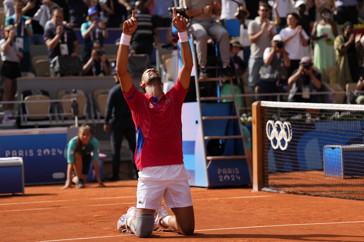 Serbia's Novak Djokovic reacts after defeating Spain's Carlos Alcaraz in the men's singles tennis final at the Roland Garros stadium during the 2024 Summer Olympics, Sunday, Aug. 4, 202 ...