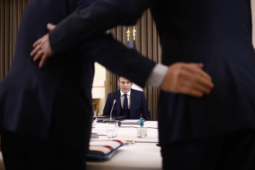 French President Emmanuel Macron, center, chairs a Defense Council on the war in Ukraine, at the Elysee Palace in Paris, Feb. 28, 2022. Within days, Russian President Vladimir Putin has achieved what  ...