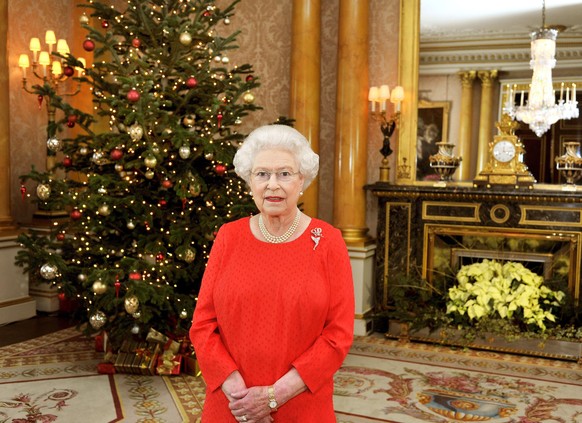 LONDON, UNITED KINGDOM - DECEMBER 19: Queen Elizabeth II stands in front of a Christmas tree at Buckingham Palace after recording her Christmas Day television broadcast to the Commonwealth on December ...