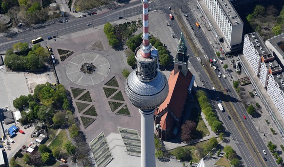 epa08386376 An aerial view of the TV tower (Fernsehturm) during sunny spring weather in Berlin, Germany, 23 April 2020 (issued 27 April 2020). Due to contact restrictions that were implemented as part ...