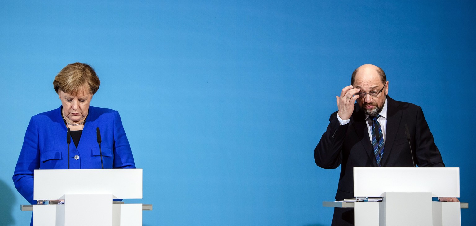 epa06432860 German Chancellor and Chairwoman of the Christian Democratic Union (CDU), Angela Merkel (L) and the leader of the Social Democratic Party (SPD), Martin Schulz (R) address a joint press con ...