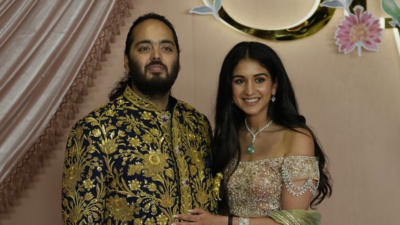 Ambani&#039;s youngest son Anant Ambani and Radhika Merchant pose for a picture during their pre-wedding ceremony in Mumbai, India, Friday, July 5, 2024. (AP Photo/Rajanish Kakade)