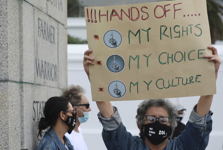 In this June 2, 2020 photo, a demonstrator holds a placard during a protest against the tobacco ban outside parliament in Cape Town, South Africa. An effort to lift South Africa���s ban on cigarette s ...