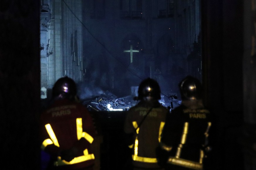 epa07509108 French firemen enter the Notre-Dame Cathedral as flames are burning the roof cathedral in Paris, France, 15 April 2019. A fire started in the late afternoon in one of the most visited monu ...