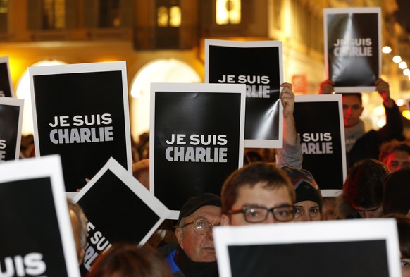 epa08109530 (FILE) - People hold placards reading &#039;Je suis Charlie&#039; (I am Charlie) during a silent gathering after the attack by masked gunmen on the satirical magazine &#039;Charlie Hebdo&# ...