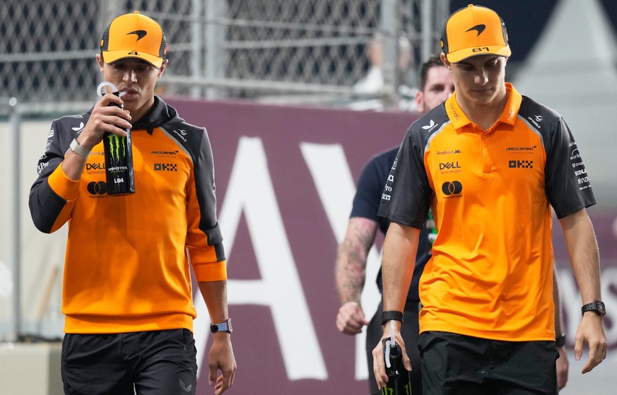 McLaren driver Lando Norris of Britain, left, and McLaren driver Oscar Piastri of Australia arrive prior to the Qatar Formula One Grand Prix, at the Lusail International Circuit, in Lusail, Qatar, Sun ...
