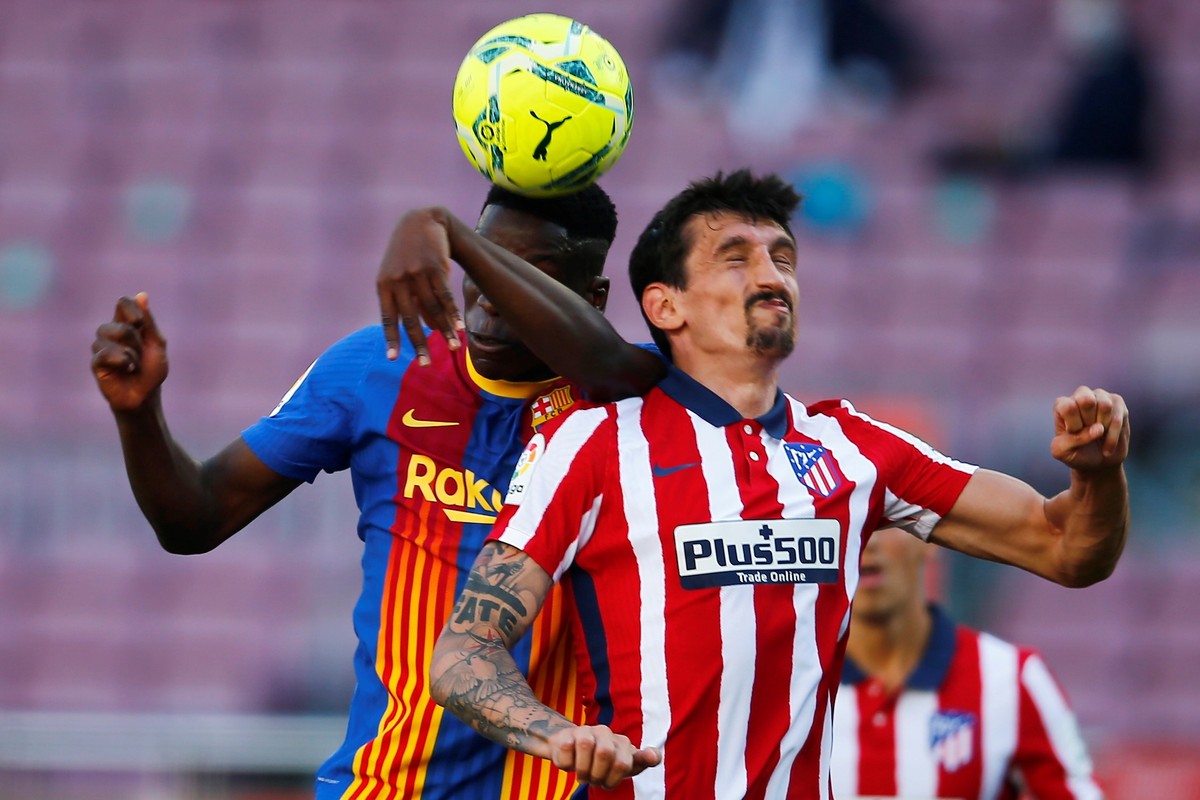 epa09185758 FC Barcelona's midfielder Ilaix Moriba (L) vies for the ball against Atletico's defender Stefan Savic (R) during the Spanish LaLiga soccer match between FC Barcelona and Atletico ...