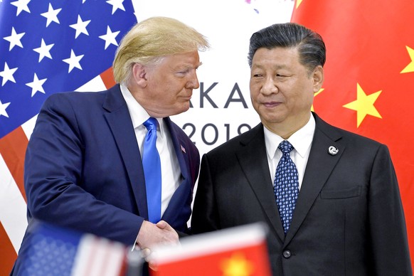 FILE - President Donald Trump, left, shakes hands with China&#039;s President Xi Jinping during a meeting on the sidelines of the G-20 summit in Osaka, Japan, June 29, 2019. (AP Photo/Susan Walsh, Fil ...