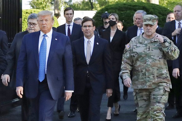 FILE - In this June 1, 2020, file photo, President Donald Trump departs the White House to visit outside St. John&#039;s Church, in Washington. Walking behind Trump from left are, Attorney General Wil ...