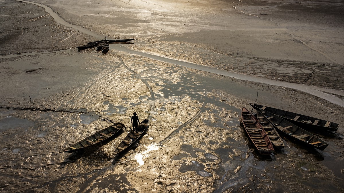 epa11606554 Aerial photograph showing a person in a stuck boat in Lago do Aleixo, Encontro das Aguas region, east of Manaus, Amazonas, Brazil, 15 September 2024. The riverside population of the metrop ...