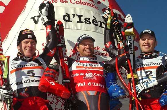 2th of the race and Swiss Didier Cuche, left, winner Austrian Stephan Eberharter, center and 3th Swiss Silvano Beltrametti, right, jubilate at the arrival area of the World Cup mens's Super-G, at ...