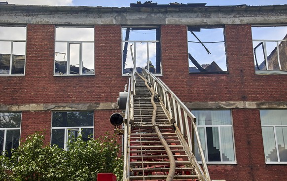 epa10098951 Ukrainian rescuers work at the site of a college shelling in Kharkiv, Ukraine, 30 July 2022. Kharkiv and surrounding areas have been the target of heavy shelling since February 2022, when  ...