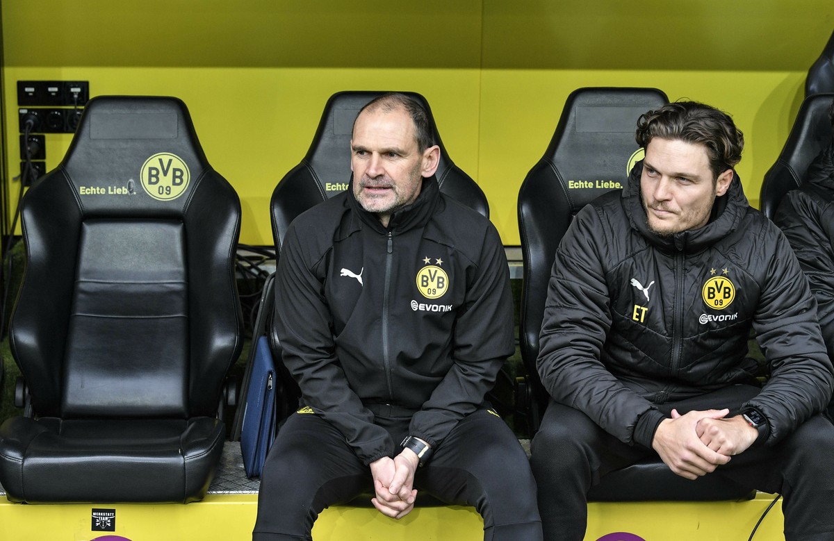 FILE - In this Saturday, Feb. 9, 2019 file photo Dortmund's assistant coaches Manfred Steves, left, and Edin Terzic sit beside the empty seat of head coach Lucien Favre, during the German Bundesl ...