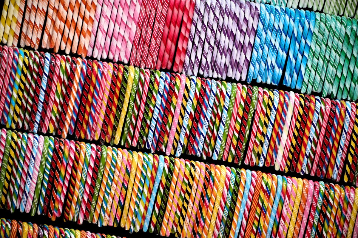 epa09719919 Colorful candy sticks are shown at the 'ISM' sweets trade fair in Cologne, Germany, 31 January 2022. The world's largest trade and supplier fair for sweets and snacks runs f ...