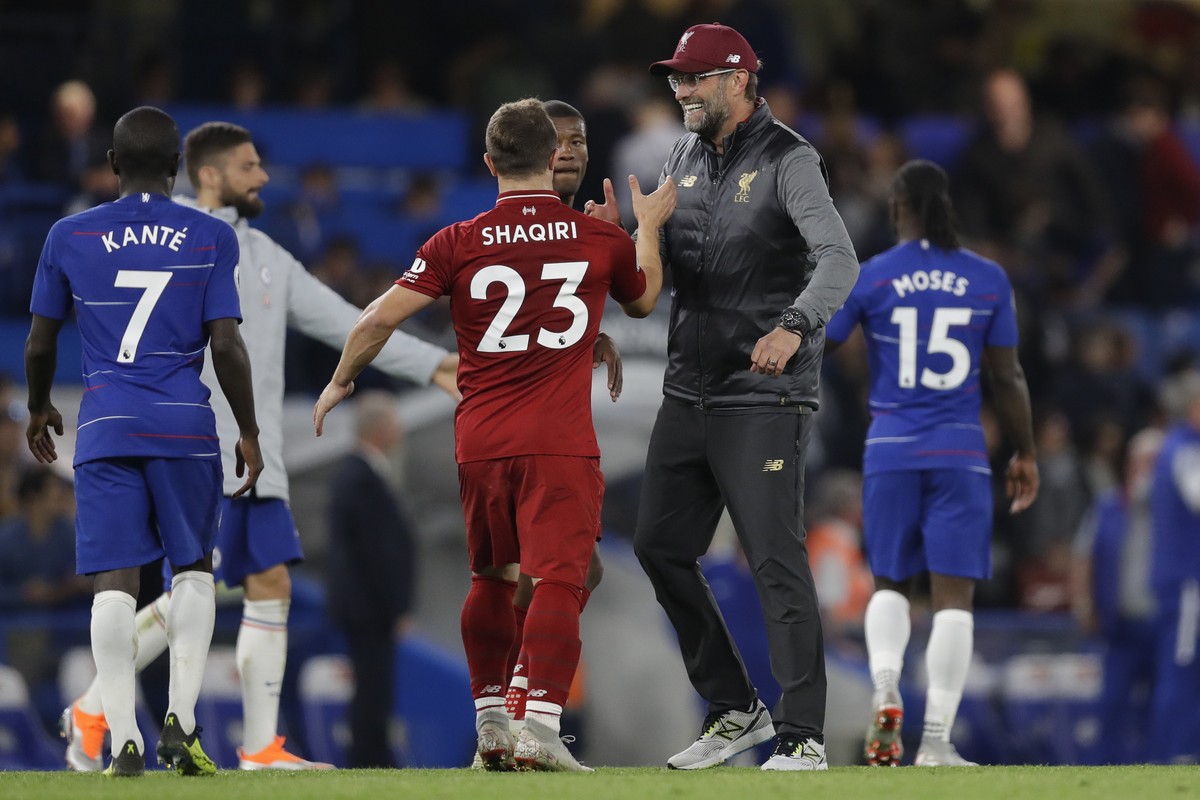 Liverpool's manager Juergen Klopp, second right, congratulates Liverpool's Xherdan Shaqiri after the English Premier League soccer match between Chelsea and Liverpool which ended in a 1-1 dr ...