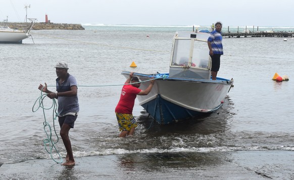 Men remove a boat from the water ahead of Hurricane Maria in the Galbas area of Sainte-Anne on the French Caribbean island of Guadeloupe, early Monday, Sept. 18, 2017. Hurricane Maria grew into a Cate ...