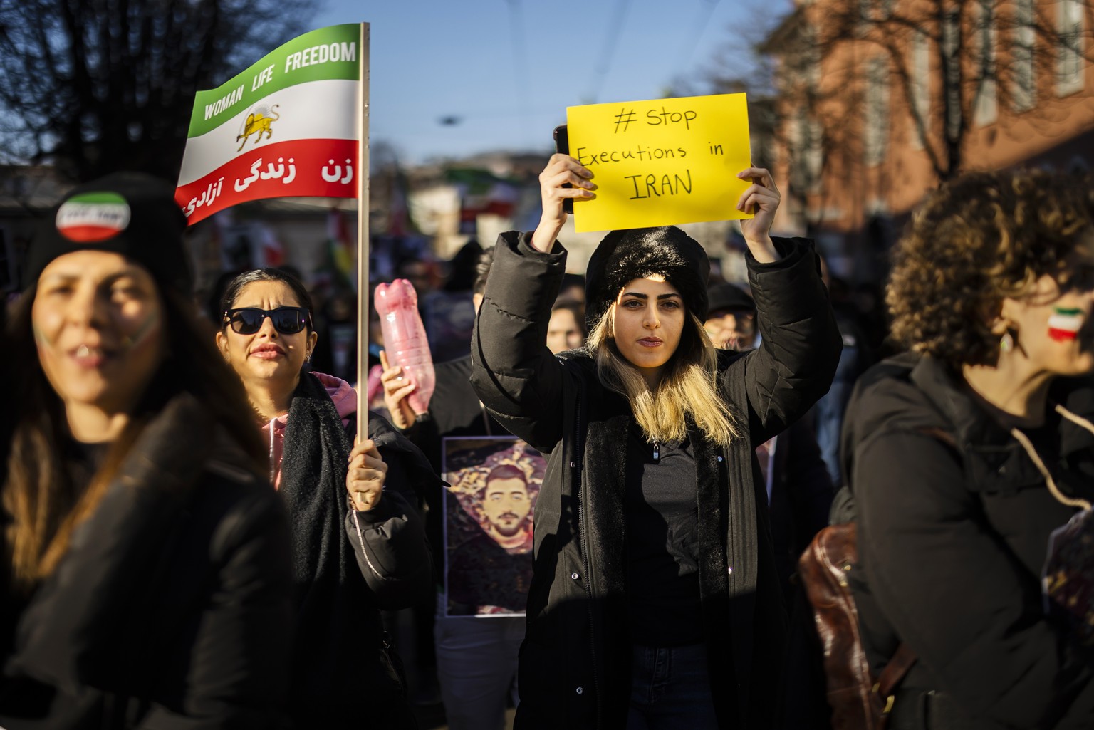 epa10394312 A man wearing the old Iranian flag attends a rally in solidarity with the protests in Iran and to honor protesters allegedly killed by the Iranian government, in Zurich, Switzerland, 07 Ja ...