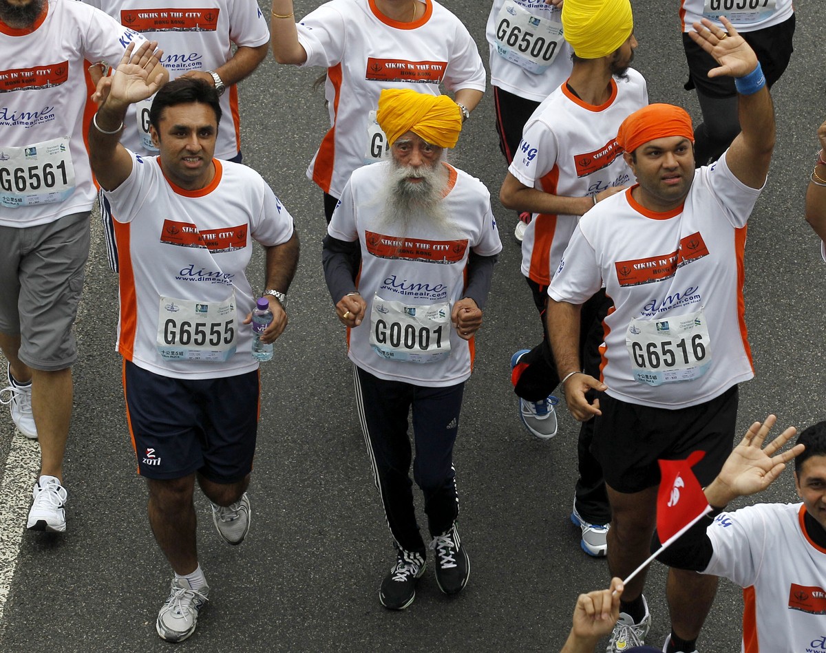 FILE - Centenarian marathon runner Fauja Singh, 101, center, originally from Beas Pind, in Jalandhar, India but who now lives in London, runs in a 10-kilometer race, part of the annual Hong Kong Marat ...