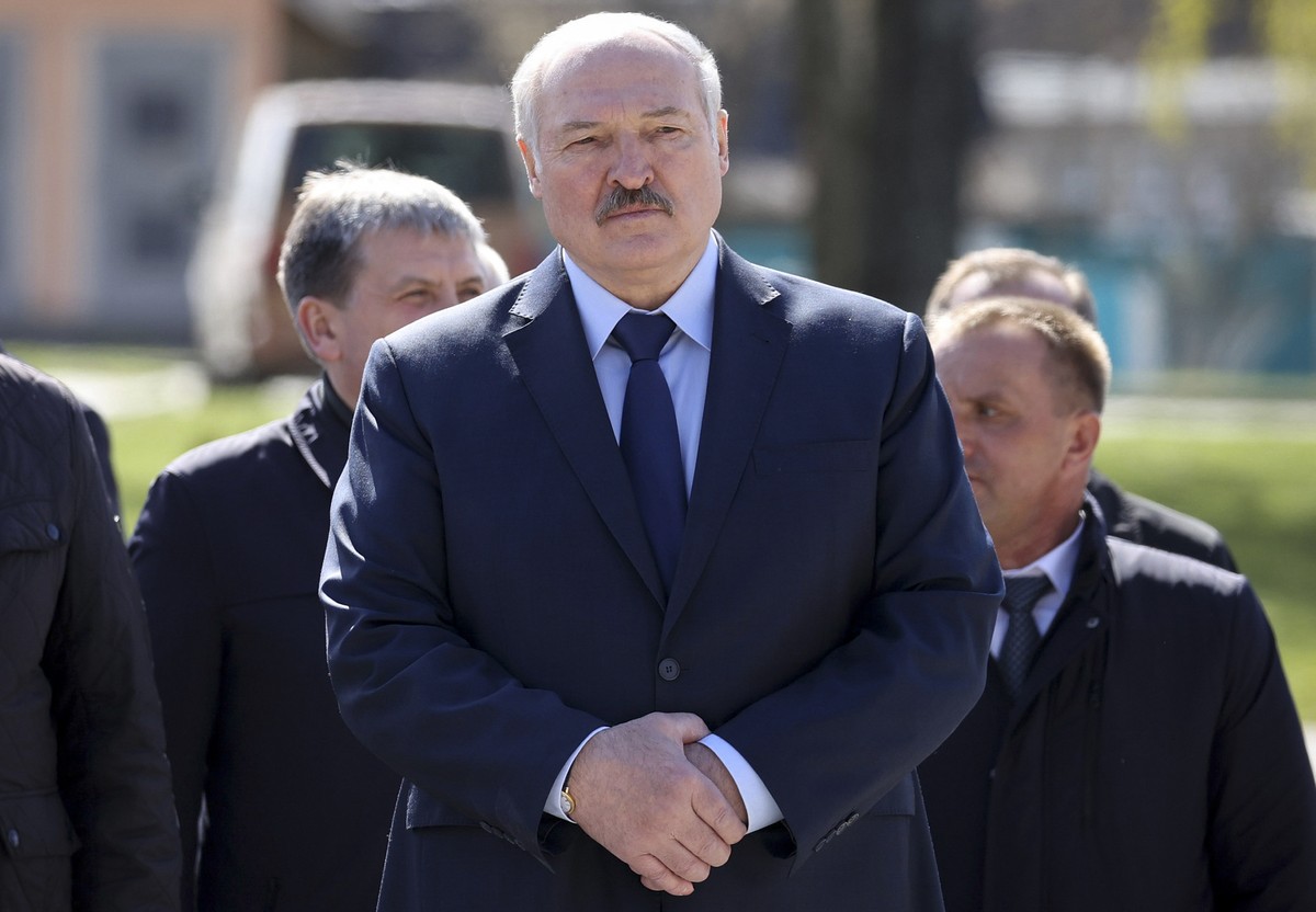 FILE - In this Monday April 26, 2021 file photo, Belarus President Alexander Lukashenko, accompanied by officials, attends a requiem rally on the occasion of the 35th anniversary of the Chernobyl disa ...