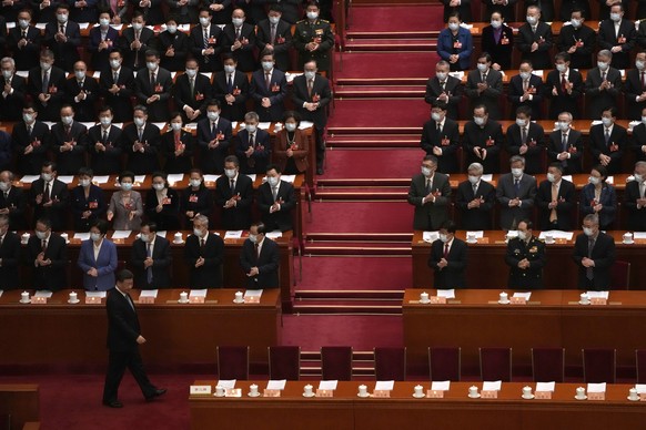 Delegates applaud as Chinese President Xi Jinping arrives for the opening session of the Chinese People&#039;s Political Consultative Congress (CPPCC) at the Great Hall of the People in Beijing, Satur ...