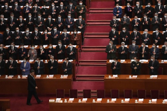 Delegates applaud as Chinese President Xi Jinping arrives for the opening session of the Chinese People's Political Consultative Congress (CPPCC) at the Great Hall of the People in Beijing, Saturday,…