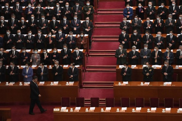 Delegates applaud as Chinese President Xi Jinping arrives for the opening session of the Chinese People&#039;s Political Consultative Congress (CPPCC) at the Great Hall of the People in Beijing, Satur ...