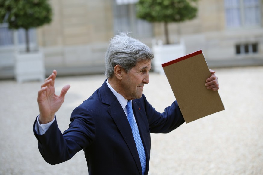 Former US Secretary of State John Kerry waves to the press after the "Tech for Good" Summit at the Elysee Palace in Paris, Wednesday, May 23, 2018. French President Emmanuel Macron seeks to ...