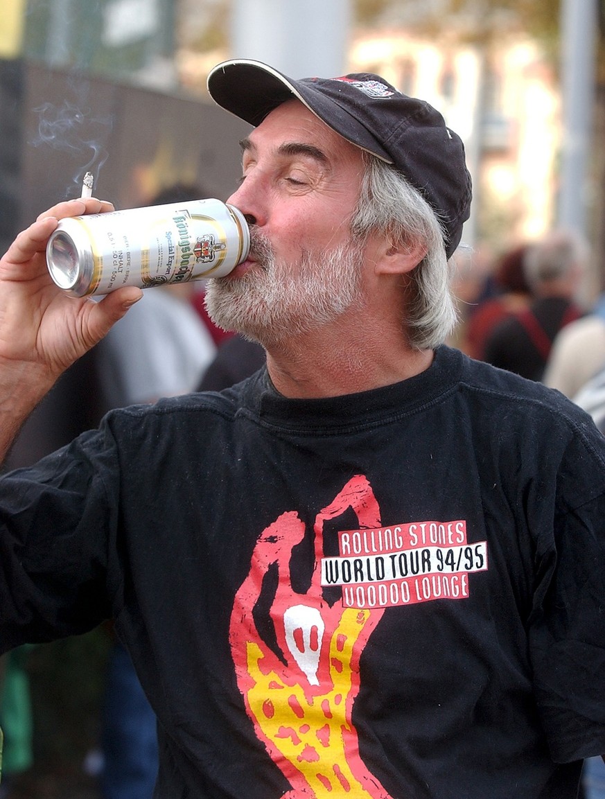A fan of British rock group &quot;The Rolling Stones&quot; drinks a beer in front of the Letzigrund stadium in Zurich, Switzerland, Thursday, October 2, 2003. The Rolling Stones are performing during  ...