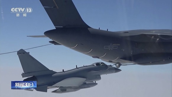 In this image, taken from video footage from Saturday, April 8, 2023 by China's CCTV, a Chinese fighter jet performs a mid-air refueling maneuver at an unspecified location.  The Chinese army...