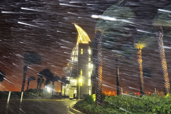Trees sway from heavy rain and wind from Hurricane Matthew in front of Exploration Tower early Friday, Oct. 7, 2016 in Cape Canaveral, Fla. Matthew weakened slightly to a Category 3 storm with maximum ...