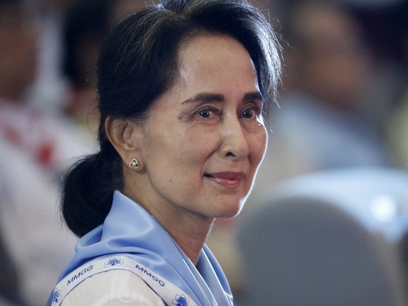 epa09676615 (FILE) - Myanmar State Counselor Aung San Suu Kyi wearing a Girl Scout uniform looks on during her swearing-in ceremony as chief of Myanmar scouts at the Yangon University Diamond Jubilee  ...