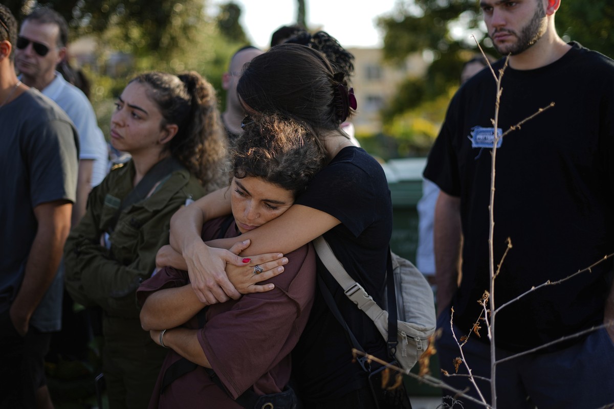 Israelis mourn next to the grave of Maya Puder, 25, during her funeral in Zikhron Ya'akov northern Israel, Thursday, Oct. 12, 2023. Puder and at least 260 more Israelis were killed by Hamas milit ...