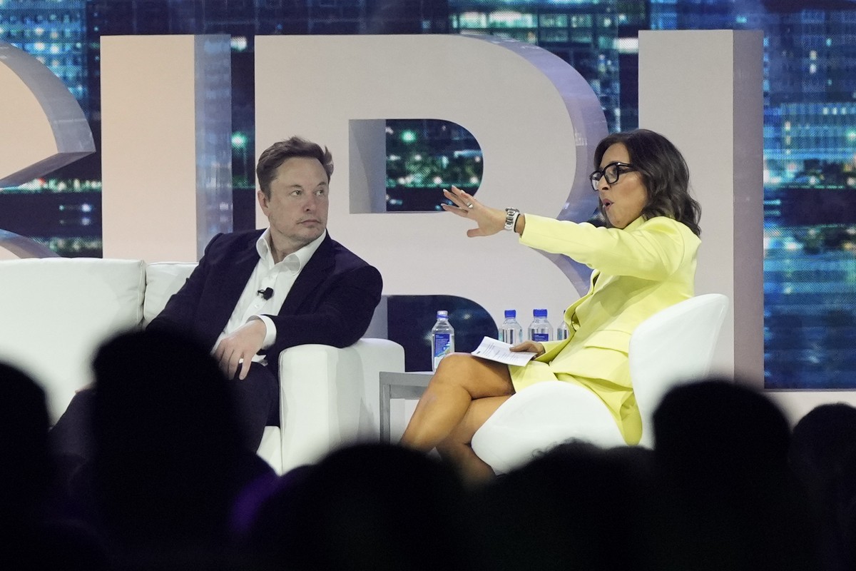 FILE - Elon Musk, left, speaks with Linda Yaccarino, April 18, 2023, in Miami Beach, Fla. The new CEO of the company formerly known as Twitter says she's spent much of the past eight weeks trying ...