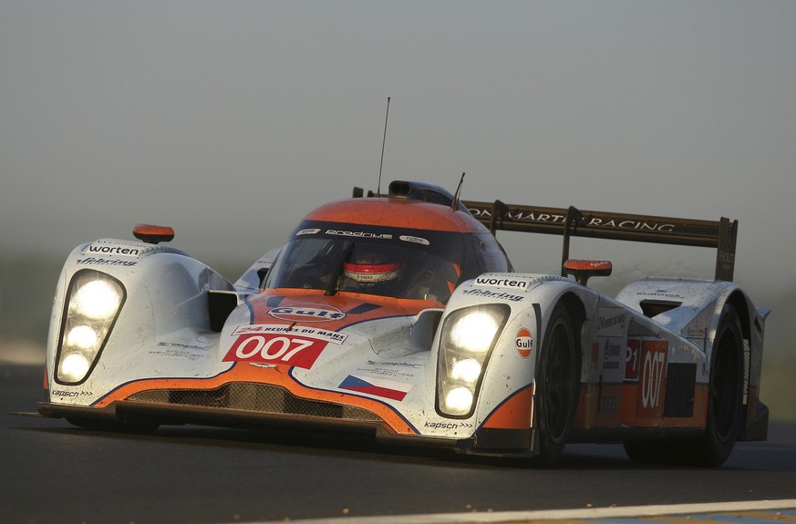 The Aston Martin No.7 driven by Jan Charouz with Tomas Enge, both of Czech Republic, and Stefan Mucke of Germany races at daybreak during the 77th Le Mans 24 Hours endurance race, in Le Mans, western ...